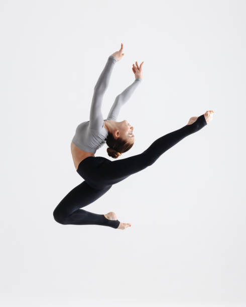 istock Young gymnast girl stretching and training 1284443417