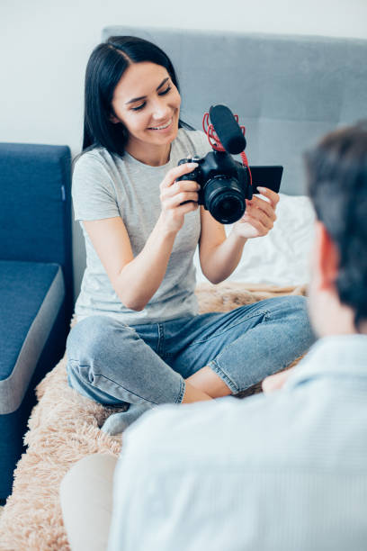 istock Smiling blogger looking at the screen while recording her video 1284447497