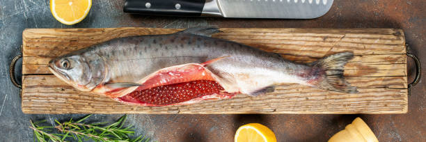istock Cutting of a salmon with caviar 1284448241