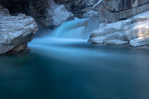 A waterfall in the alps in The Uriezzo gorge, horizontal  pics and long exposure - Piedmont Italy