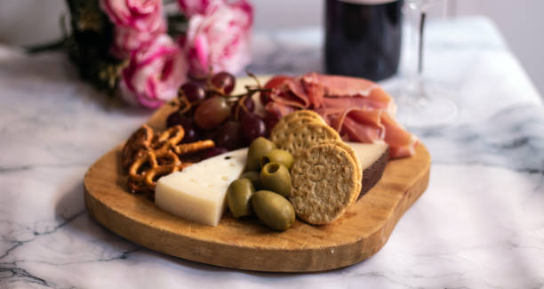 istock charcuterie plater, with cheese, crackers, tomatoe, olives, 1284454403