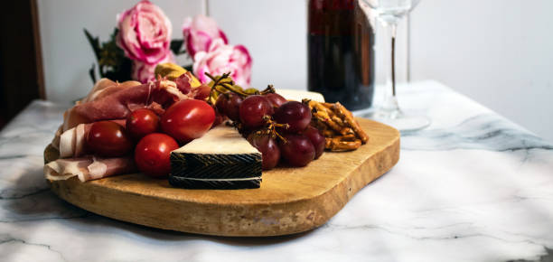 istock charcuterie plater, with cheese, crackers, tomatoe, olives, 1284454586