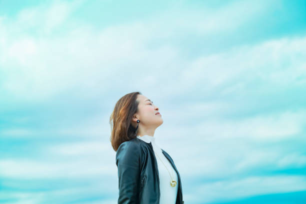 istock asian woman looking up at the sky 1284455605