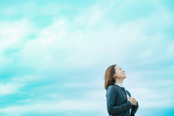 istock asian woman looking up at the sky 1284455619