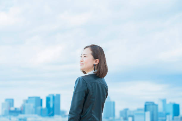 istock asian woman looking up at the sky 1284455632
