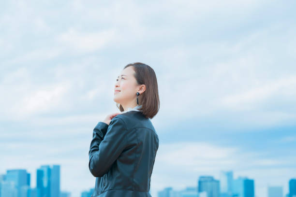 istock asian woman looking up at the sky 1284455669