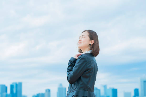 istock asian woman looking up at the sky 1284455681