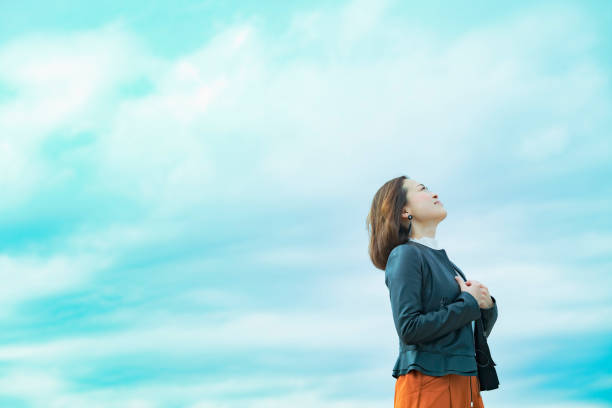 istock asian woman looking up at the sky 1284455761