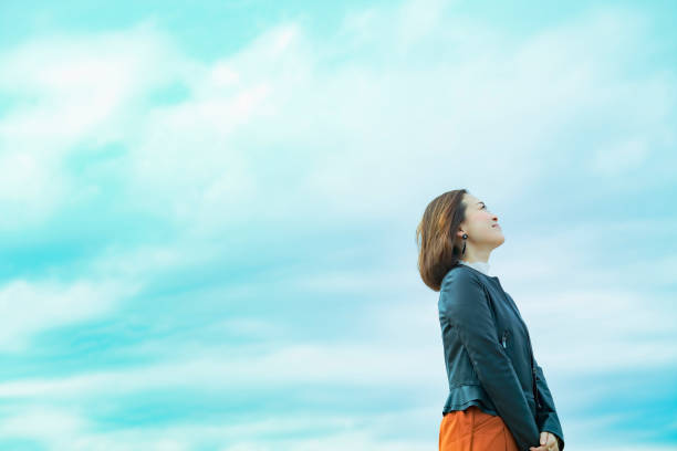 Woman with diabetes wearing a continuous glucose monitoring system and admiring the view