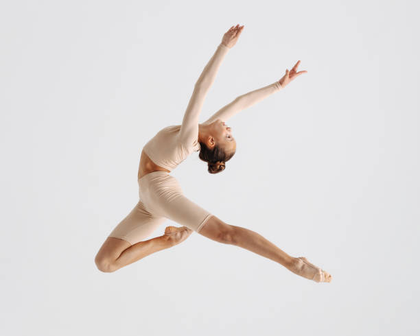 istock Young gymnast girl stretching and training 1284457814