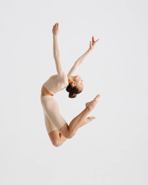 istock Young gymnast girl stretching and training 1284458334