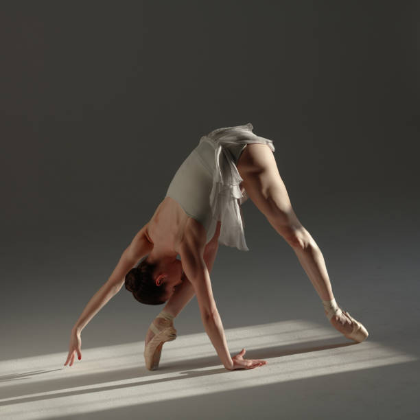 istock Young beautiful ballerina is posing in studio 1284458981