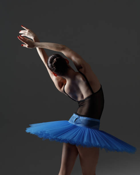 istock Young beautiful ballerina is posing in studio 1284459499