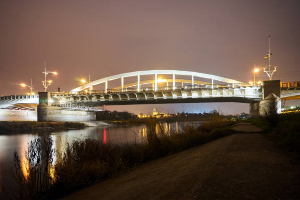 istock Steel structure of road bridge over the Warta river at night 1284459502