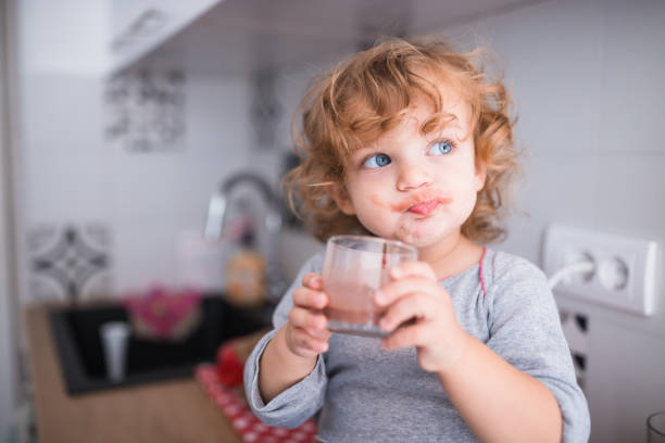 istock Adorable happy child drinking chocolate milk 1284459504