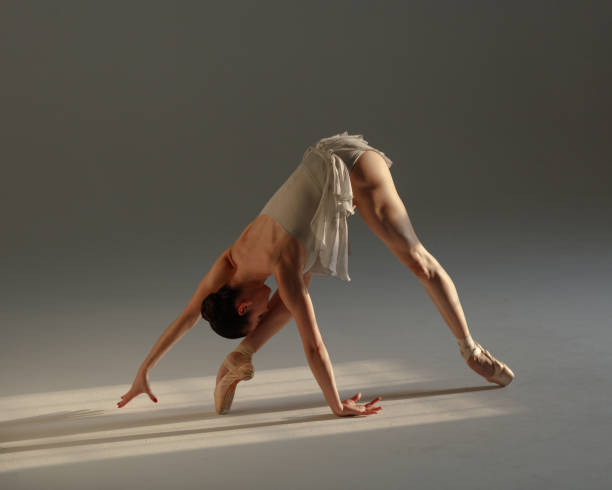 istock Young beautiful ballerina is posing in studio 1284459628
