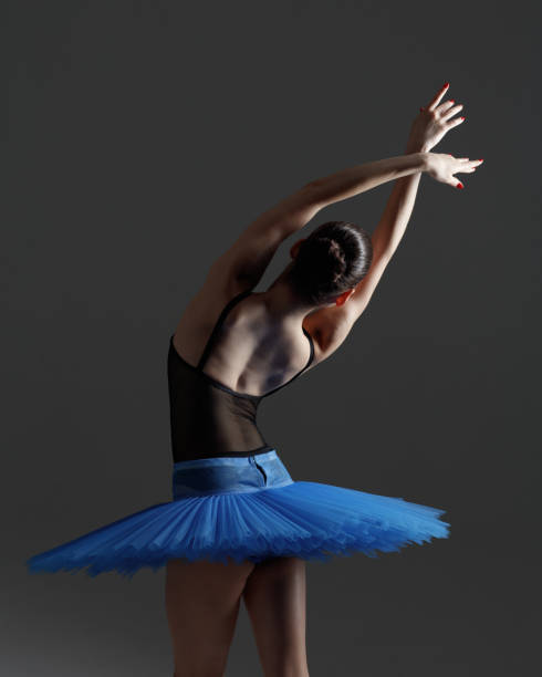 istock Young beautiful ballerina is posing in studio 1284459645