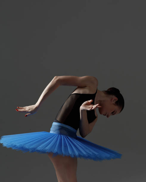 istock Young beautiful ballerina is posing in studio 1284459757