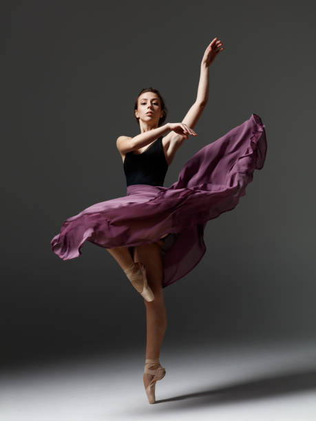 istock Young beautiful ballerina is posing in studio 1284460823