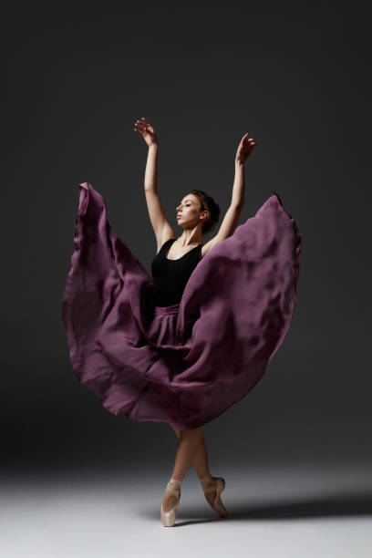 istock Young beautiful ballerina is posing in studio 1284460874