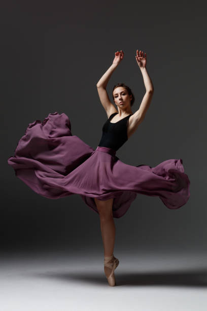 istock Young beautiful ballerina is posing in studio 1284460886