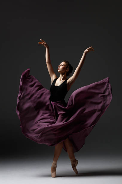 istock Young beautiful ballerina is posing in studio 1284460919