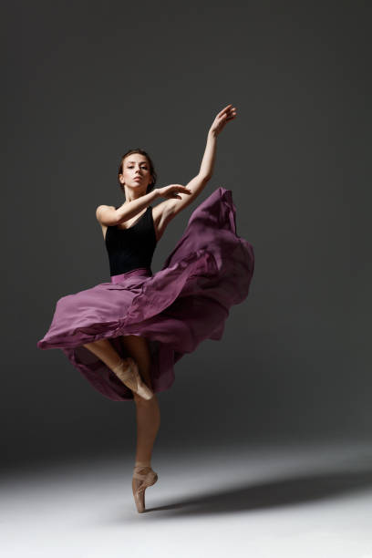 istock Young beautiful ballerina is posing in studio 1284460930