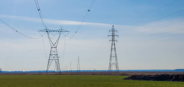 istock Farmland after plowing with electric pylon 1284460962