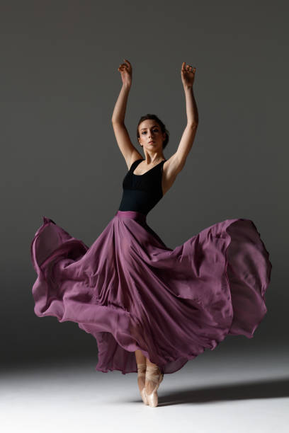istock Young beautiful ballerina is posing in studio 1284461032