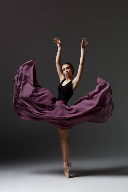 istock Young beautiful ballerina is posing in studio 1284461068