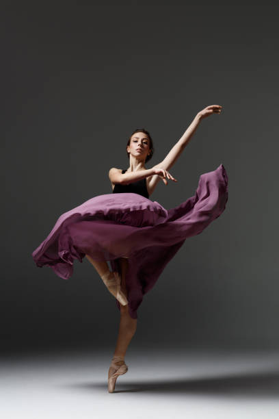 istock Young beautiful ballerina is posing in studio 1284461122