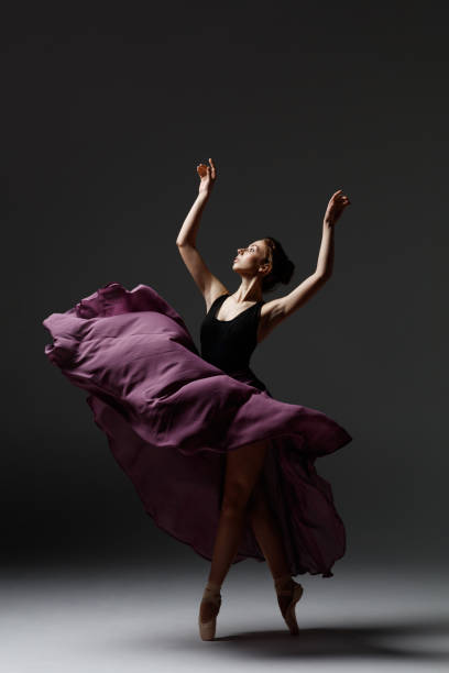 istock Young beautiful ballerina is posing in studio 1284461194