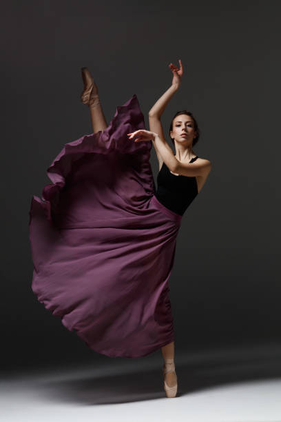 istock Young beautiful ballerina is posing in studio 1284461198