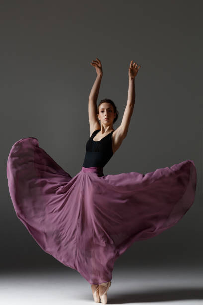 istock Young beautiful ballerina is posing in studio 1284461207