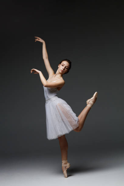 istock Young beautiful ballerina is posing in studio 1284461744