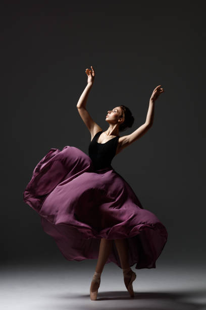 istock Young beautiful ballerina is posing in studio 1284461773