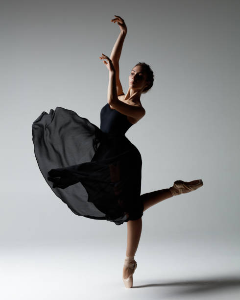 istock Young beautiful ballerina is posing in studio 1284461859