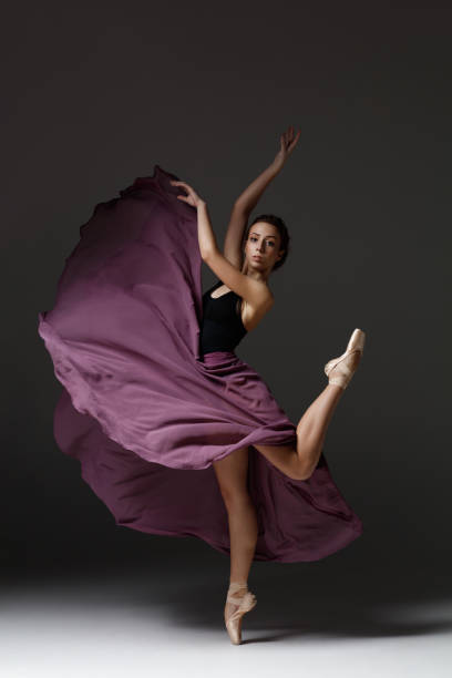 istock Young beautiful ballerina is posing in studio 1284461877