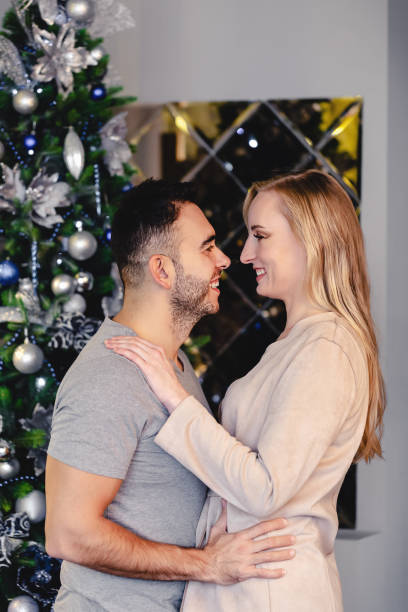 istock family couple hugging over Christmas tree 1284461926