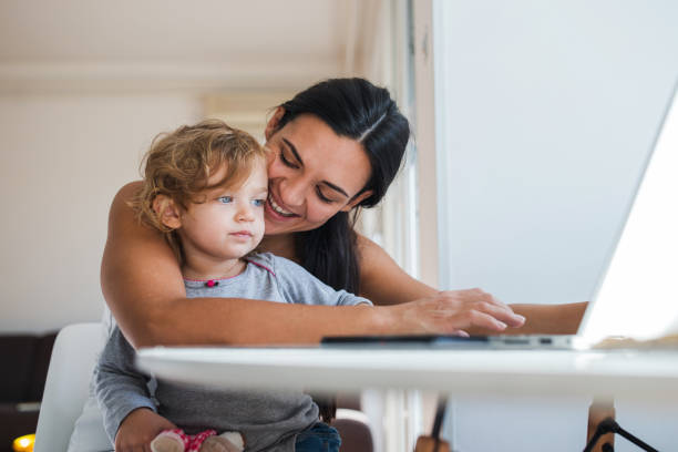 istock Mother and daughter using laptop 1284463795