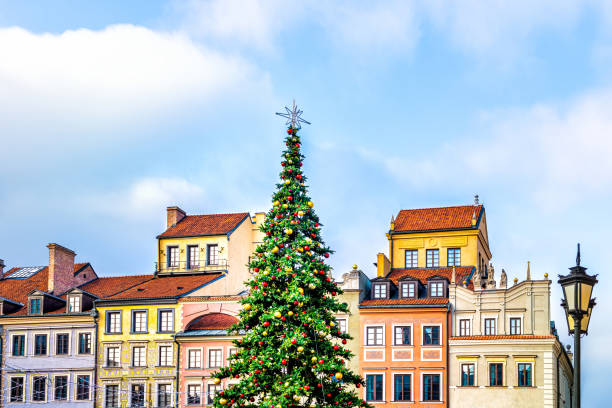 istock New Year Christmas tree decorated with illumination ornaments by multicolored architecture of old town market square in Warsaw, Poland 1284464420