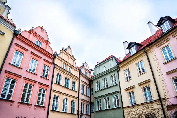 Warsaw, Poland Old town square with historic street town architecture windows multicolored pattern of pink, yellow vintage color colorful apartment buildings