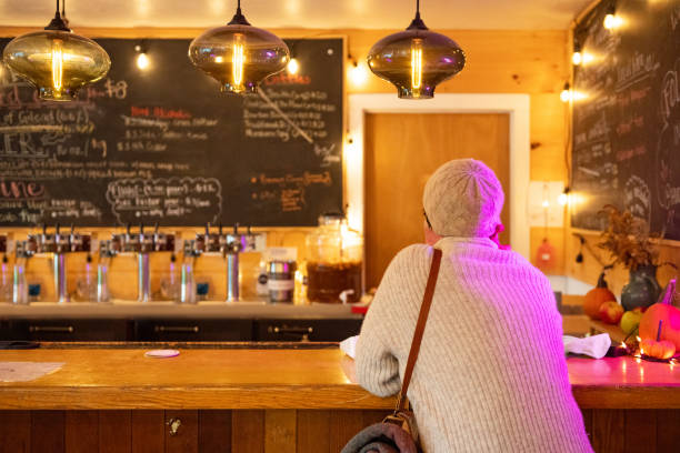 istock Back of Non Binary Person in 30s Ordering Drinks at a Hudson Valley Farm's Cider Bar 1284468036