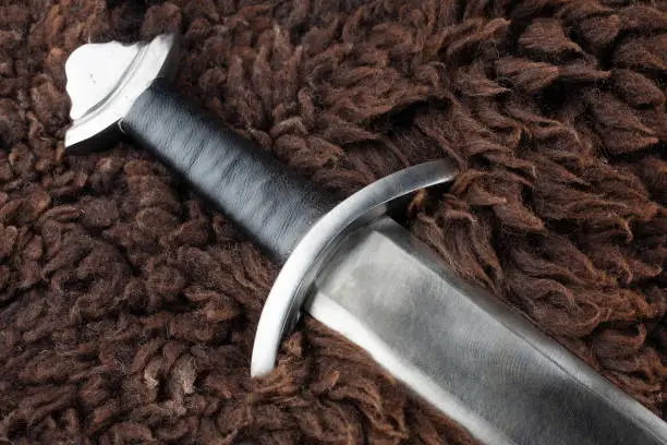 Viking Age sword on sheep fur background
