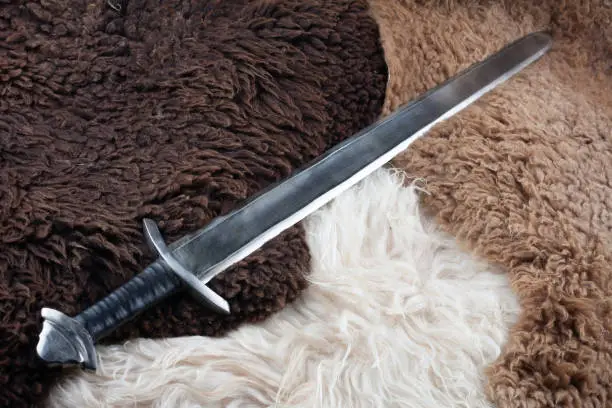 Viking Age sword on sheep fur background