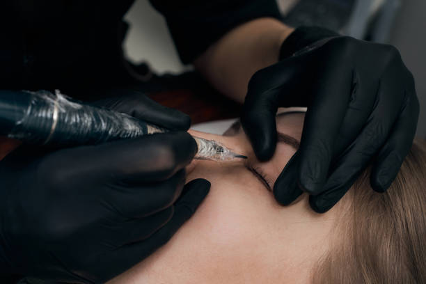 istock Permanent eyebrow makeup procedure. Eyebrow tattooing, process. The use of tools by a master for permanent eyebrow makeup. 1284472637
