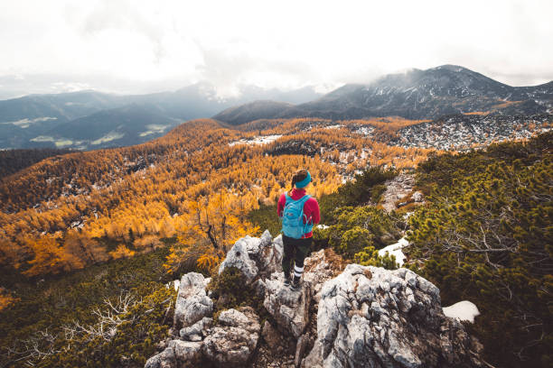 istock Woman hiker with backpack descending down the mountain 1284472753