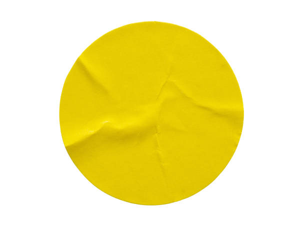 istock Yellow round paper sticker label isolated on white background 1284472841