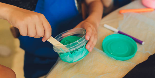 istock Ingredient for make home made Toy Called Slime, Teenager having fun and being creative homemade slime. Selective focus on Slime. 1284472941
