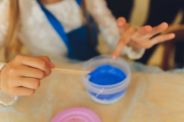 istock Ingredient for make home made Toy Called Slime, Teenager having fun and being creative homemade slime. Selective focus on Slime. 1284472942